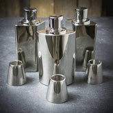 hip flasks in sterling silver  3 placed on marble surface